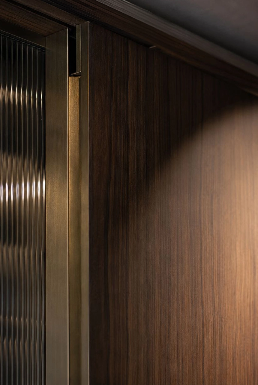 X4 Design and Build dark wood panel and metal profile detail with ribbed glass texture, vertical shadow gap, concealed transition, and premium fit-out finishing